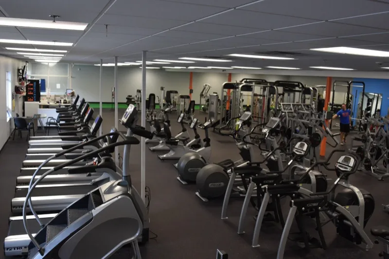 Row of treadmills and elliptical machines in the cardio area