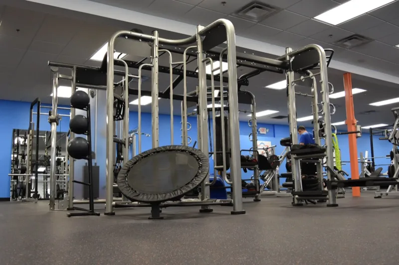 Functional training rig with mini trampoline and cable machines